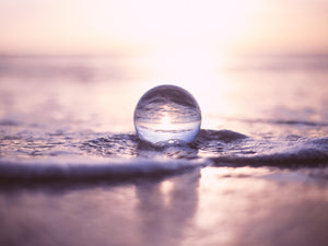 Much as dream imagery, this crystal clear sphere flips and distorts the beautiful sea-surf image, leaving us to decode the vision. Enveloped in hues of regal purples, seafoam encircles the orb. Dreamwork Coaching teaches and supports your soul growth.